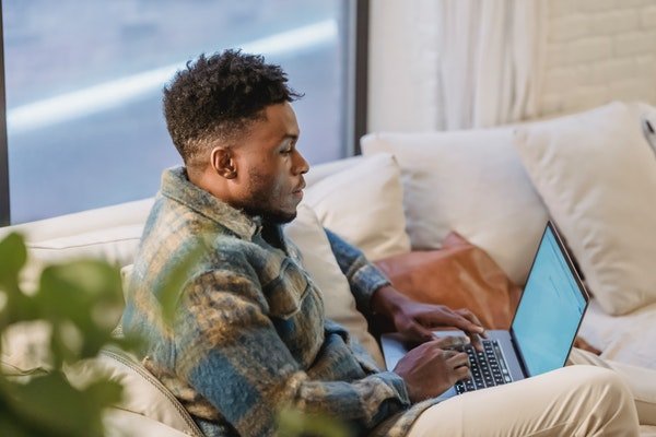 Photo of a man using his laptop at home. 