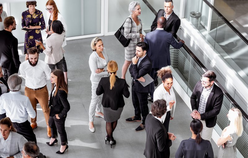 A group of mortgage professionals speaking at a networking event. 