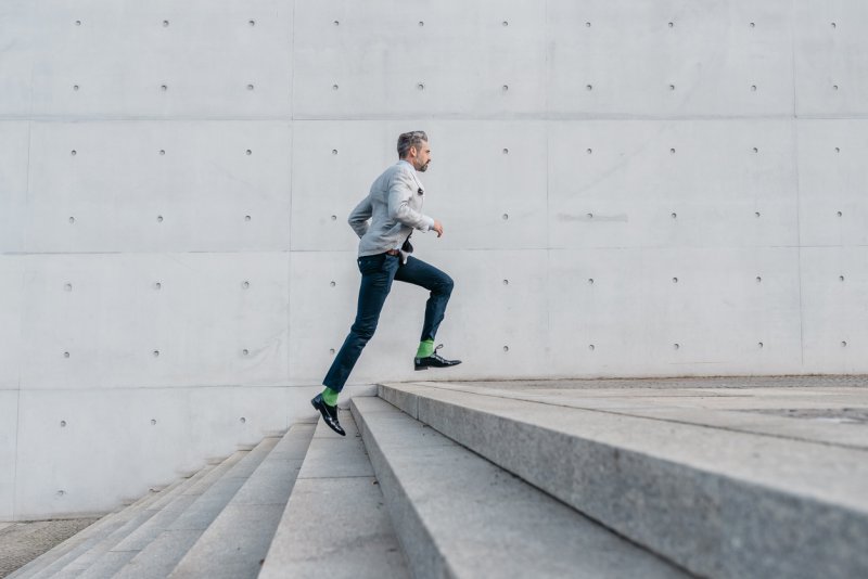 A loan officer running up stairs.