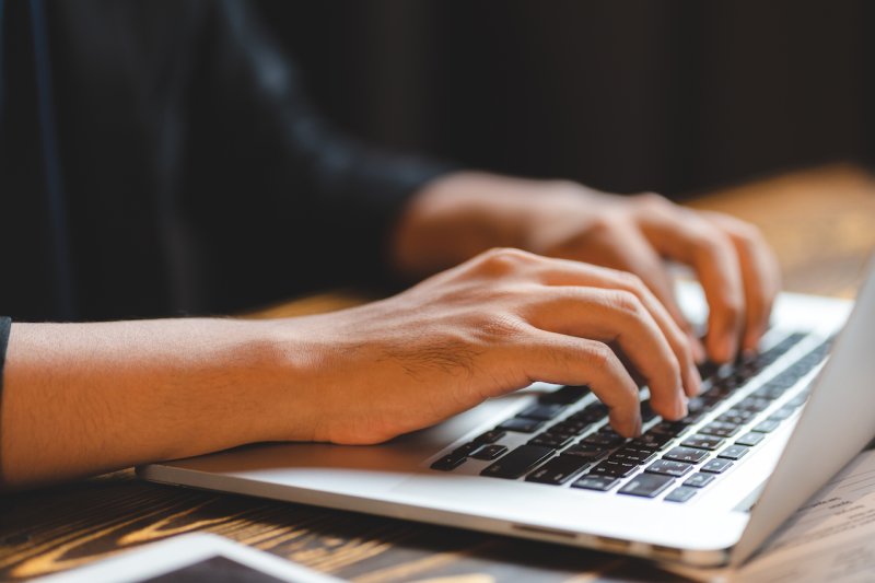 Someone typing on a computer