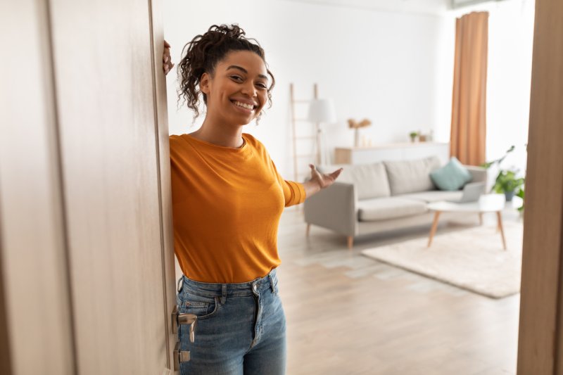 A single woman homeowner welcoming the viewer into her home. 